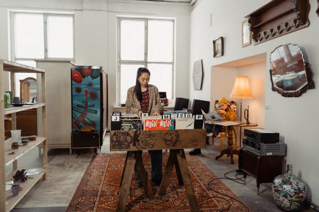 A woman browses vinyl records in a vintage-style shop with warm interior decor and music ambiance.